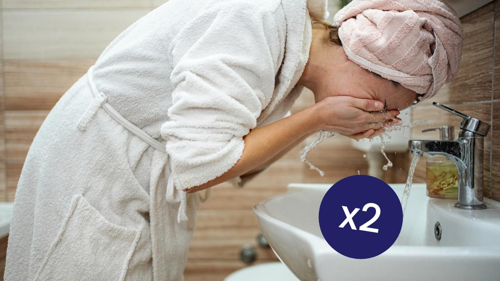 woman washing face over sink