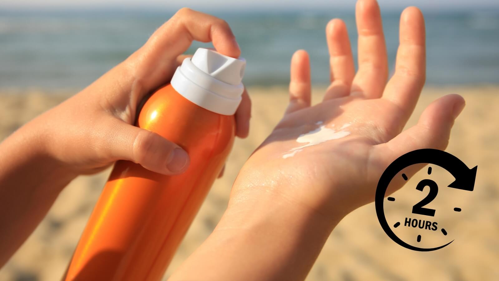 closeup of person spraying sunscreen on hand