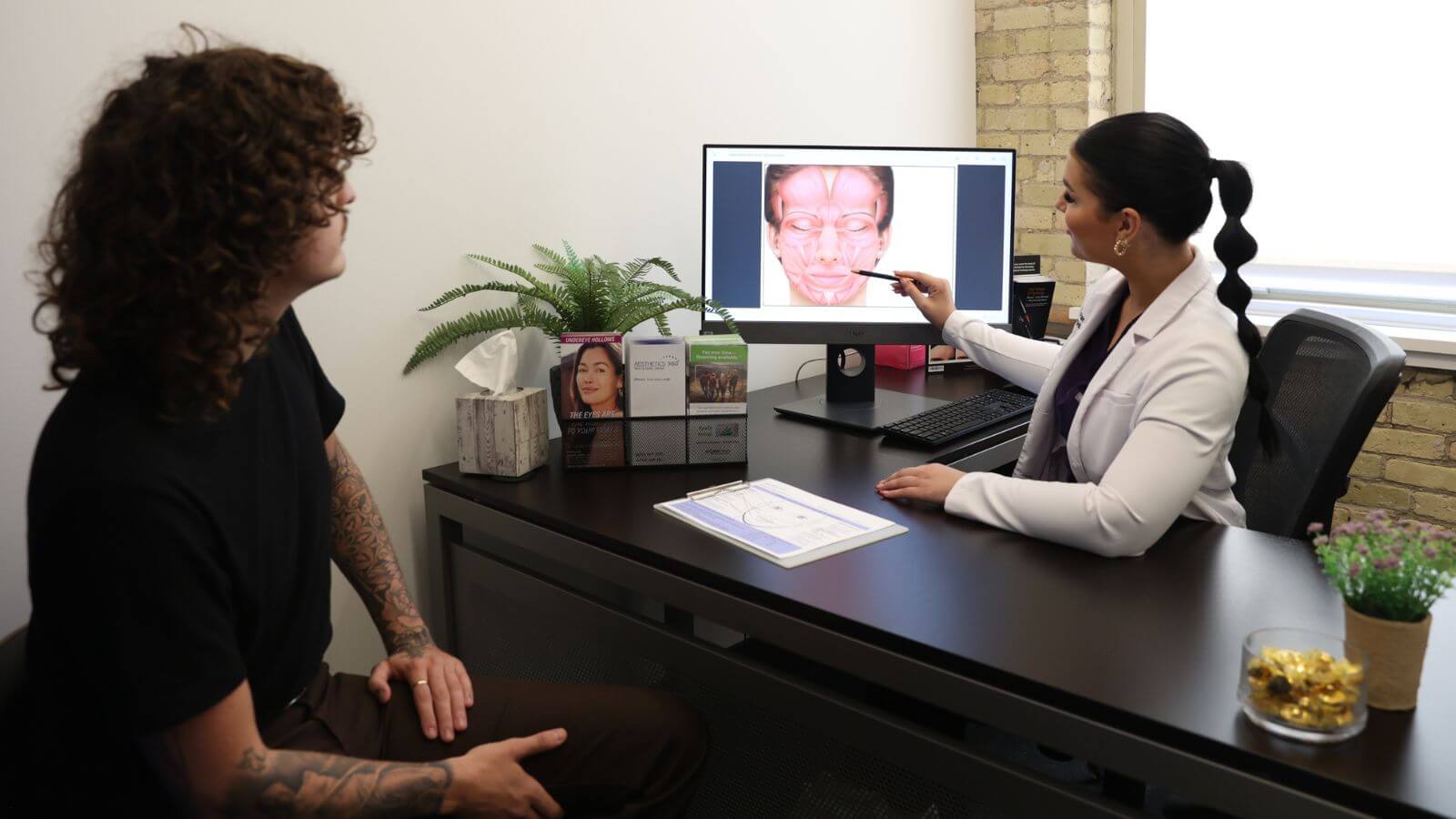 doctor explaining botox aftercare procedures to patient on computer screen