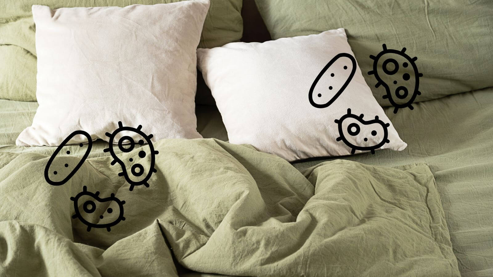 pillows on bed with germ icons overlayed